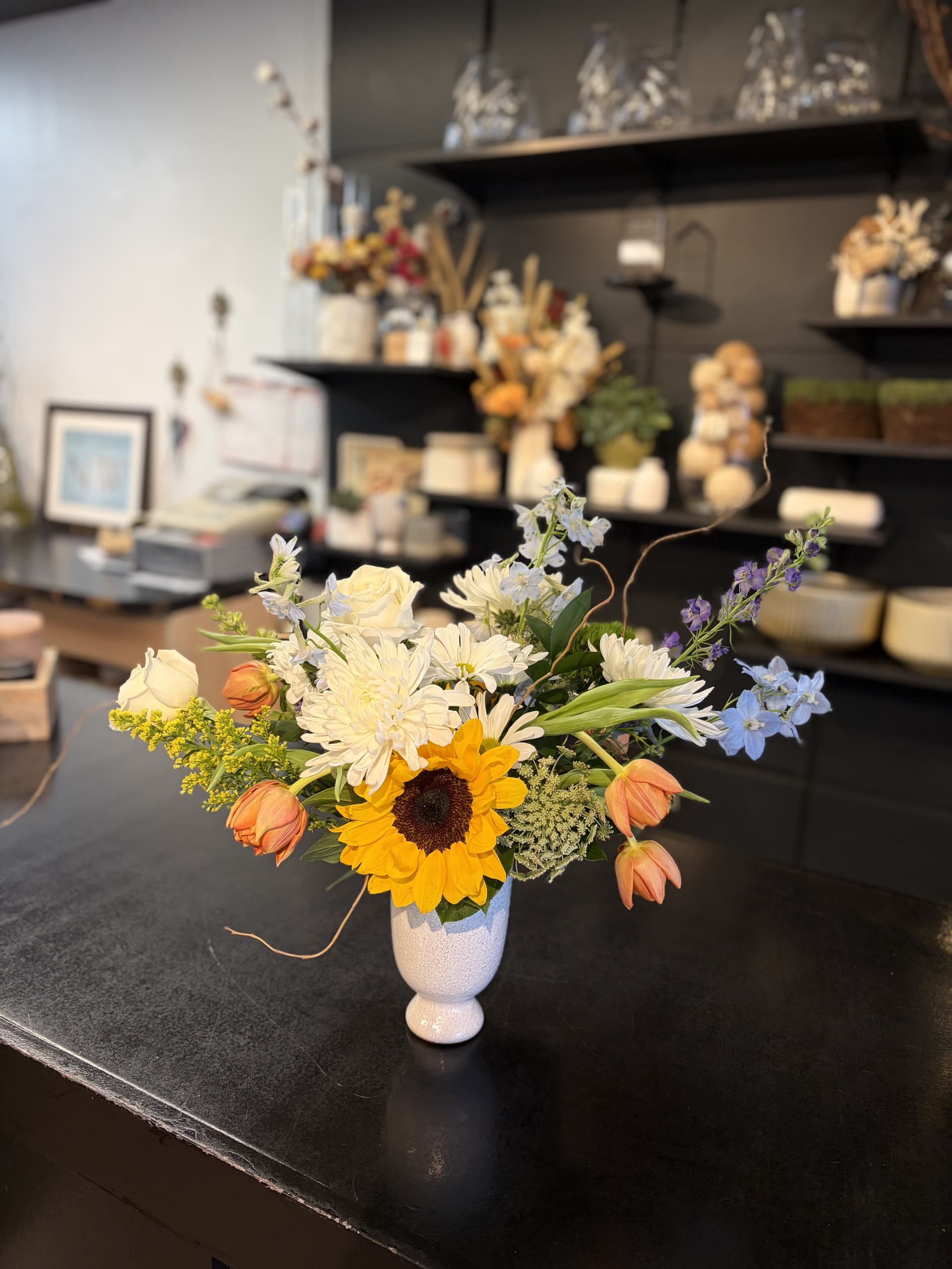 Pedestal vase — sunflowers, mums, delphinium, and tulips