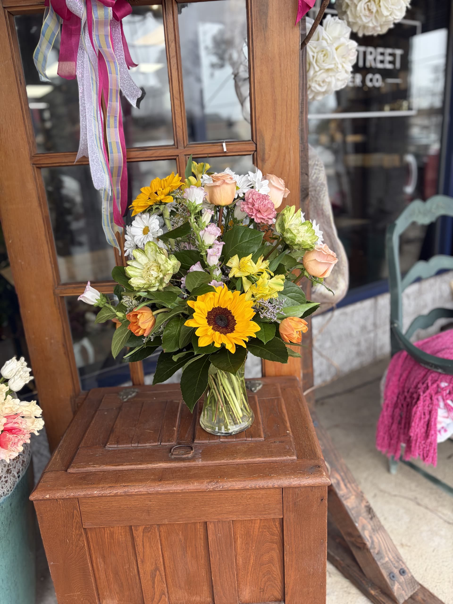 Seasonal mix — sunflowers, peach roses, and mixed blooms